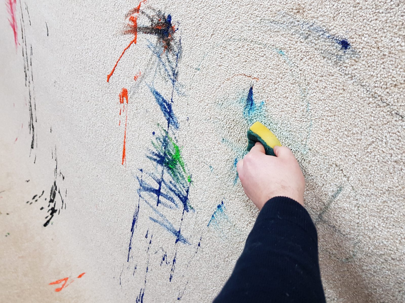 Scrubbing the paint scribbles off with a sponge