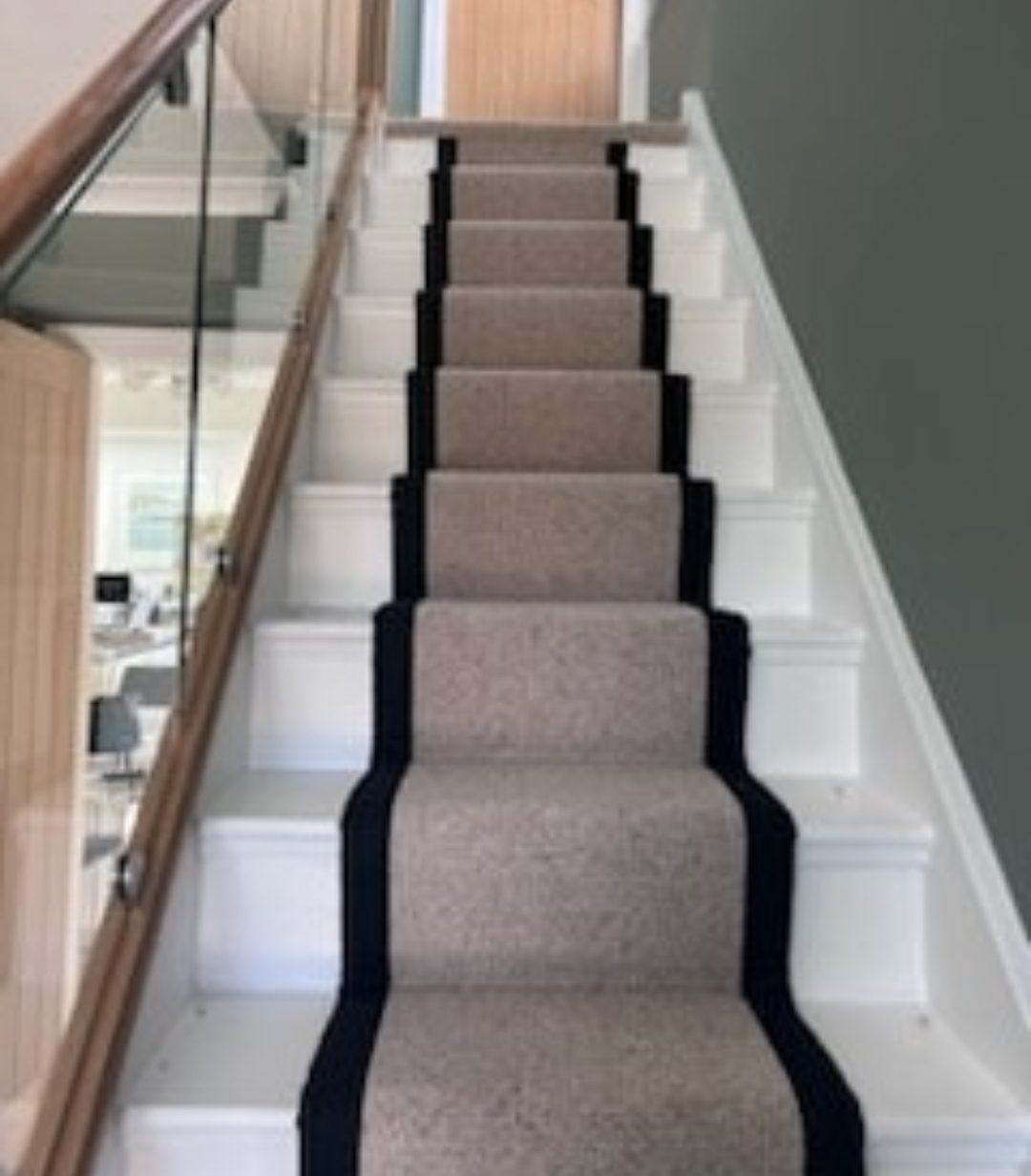 Grey stair runner with black border on white staircase
