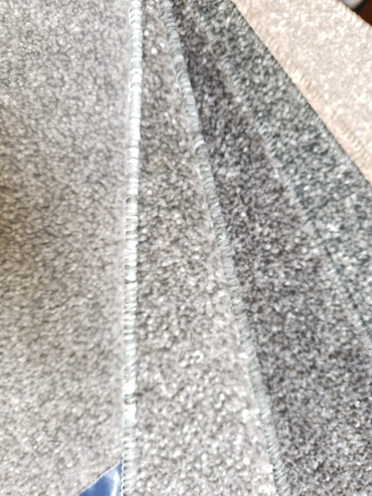 Sparkle-fleck grey carpet close up on stairs