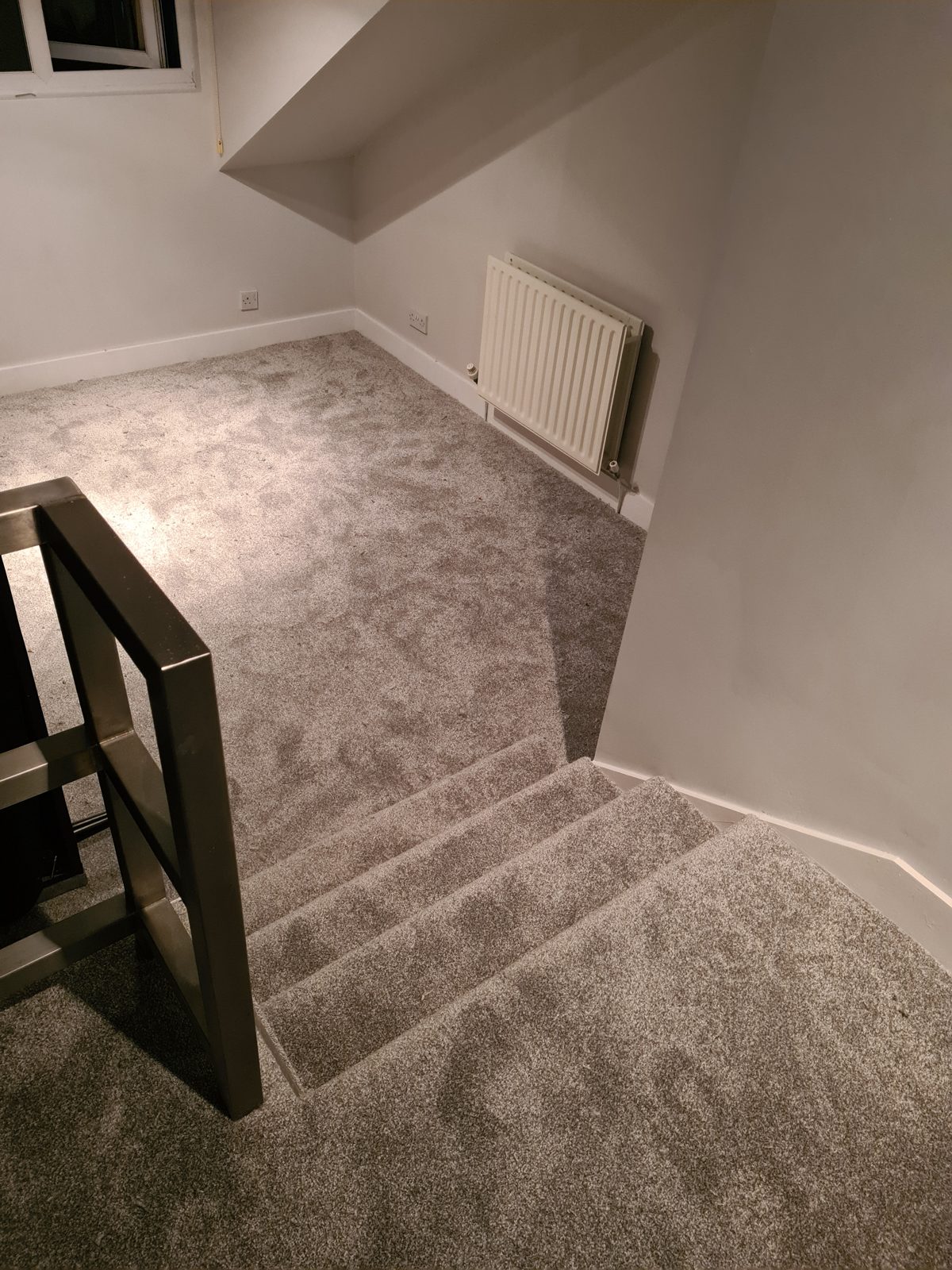 Soft grey carpet across an open-plan room and stairs