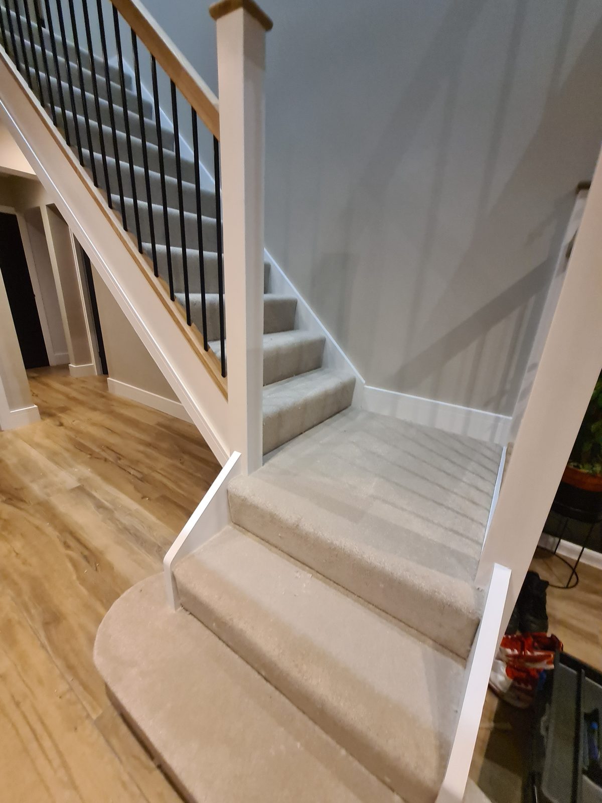 Carpeted landing with oak flooring below