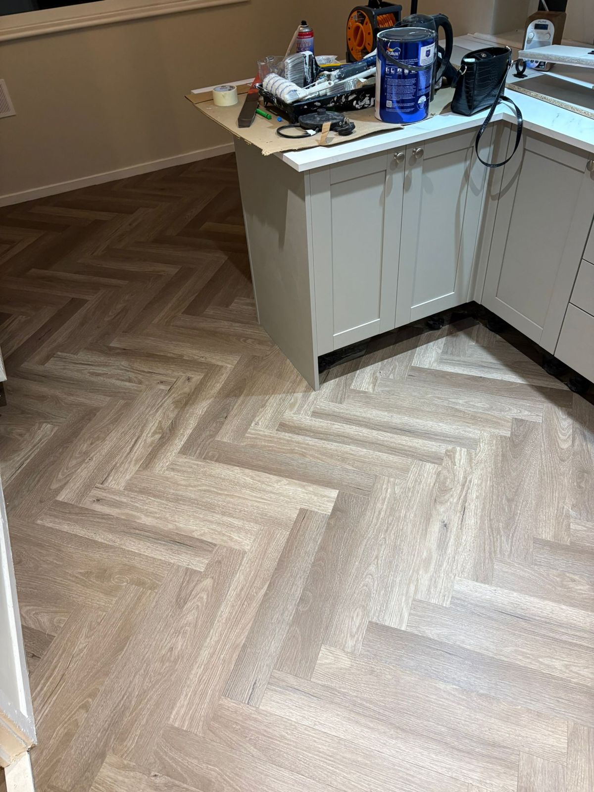 Herringbone flooring being fitted in a kitchen