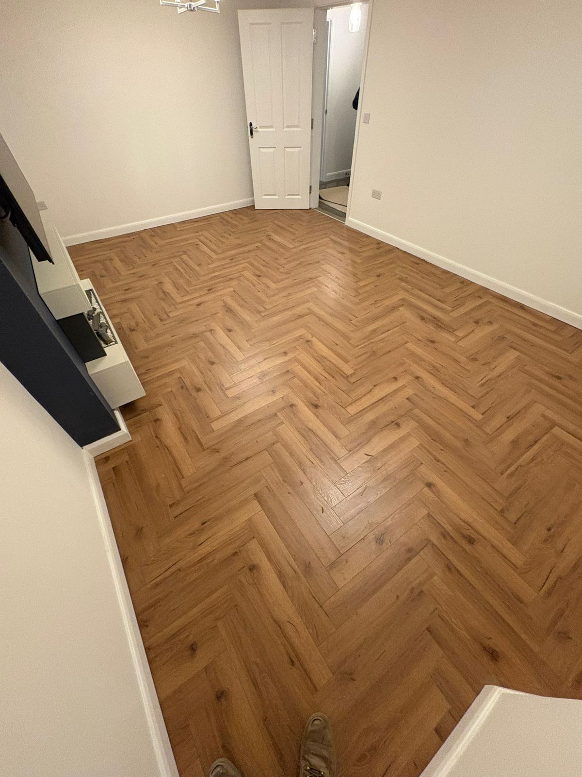 Warm oak herringbone flooring in a lounge