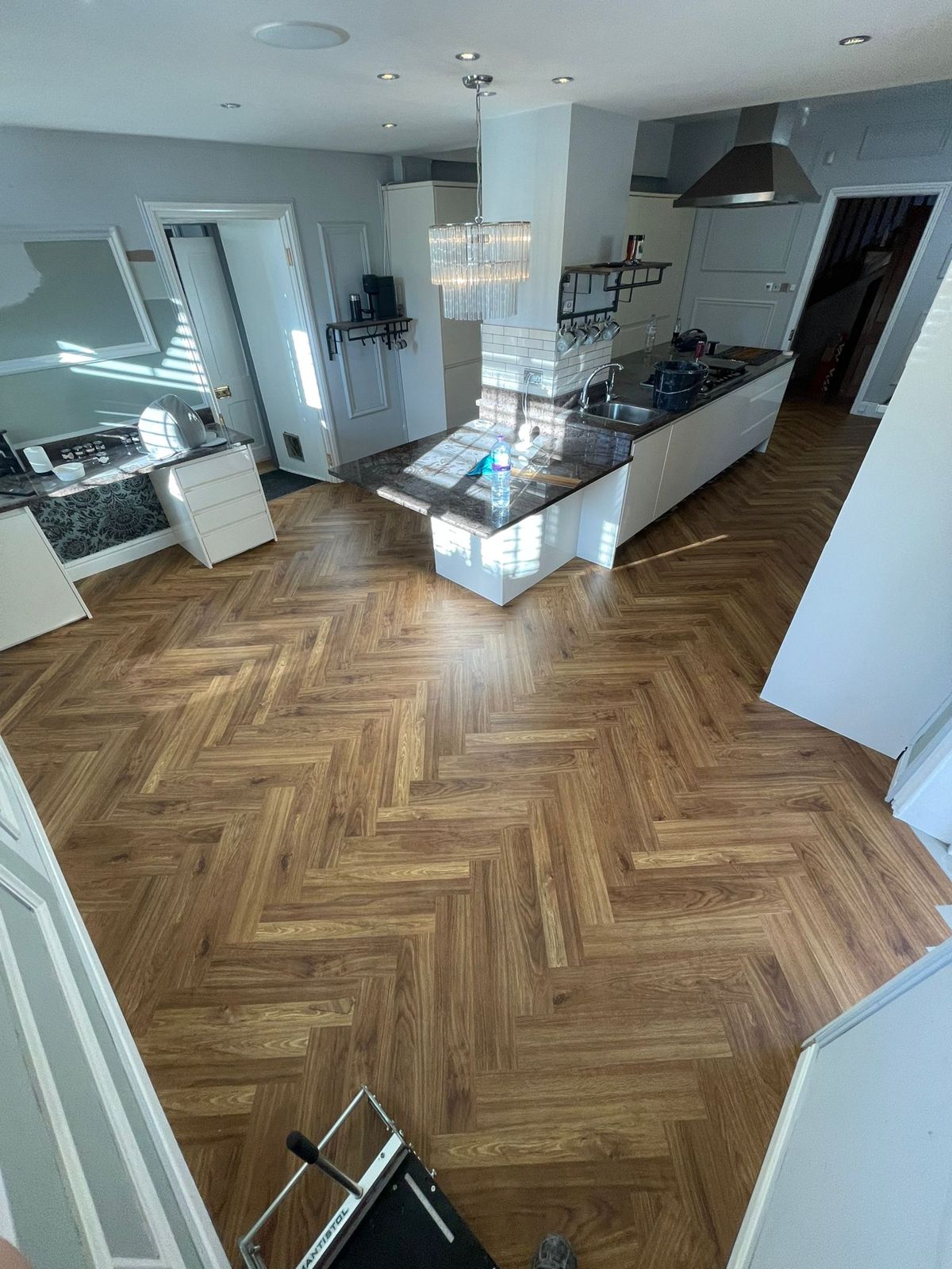 Golden oak herringbone LVT in an open-plan Warrington kitchen